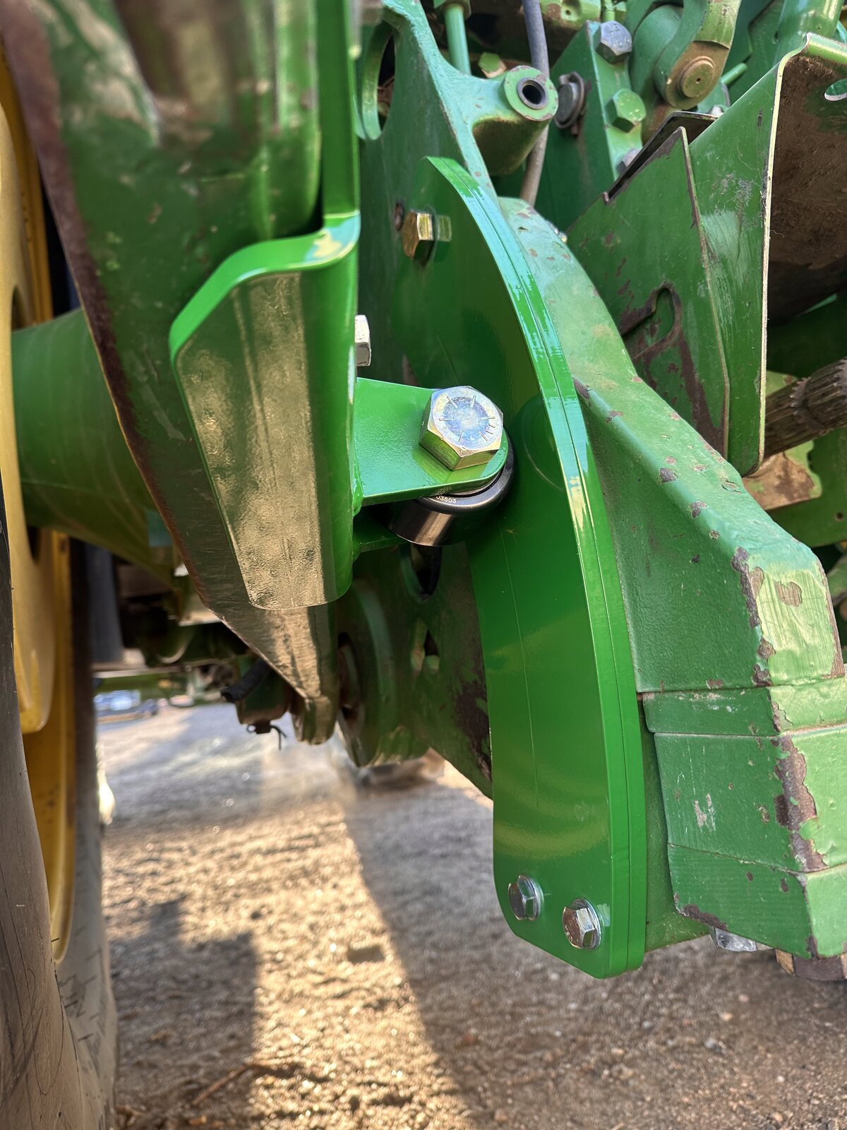 RollerGlide Heritage bracket viewed from underneath &mdash; wraparound arm design for maximum strength on John Deere 8000 Series